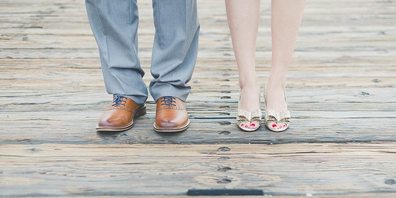 Couple's shoes on a wooden boardwalk