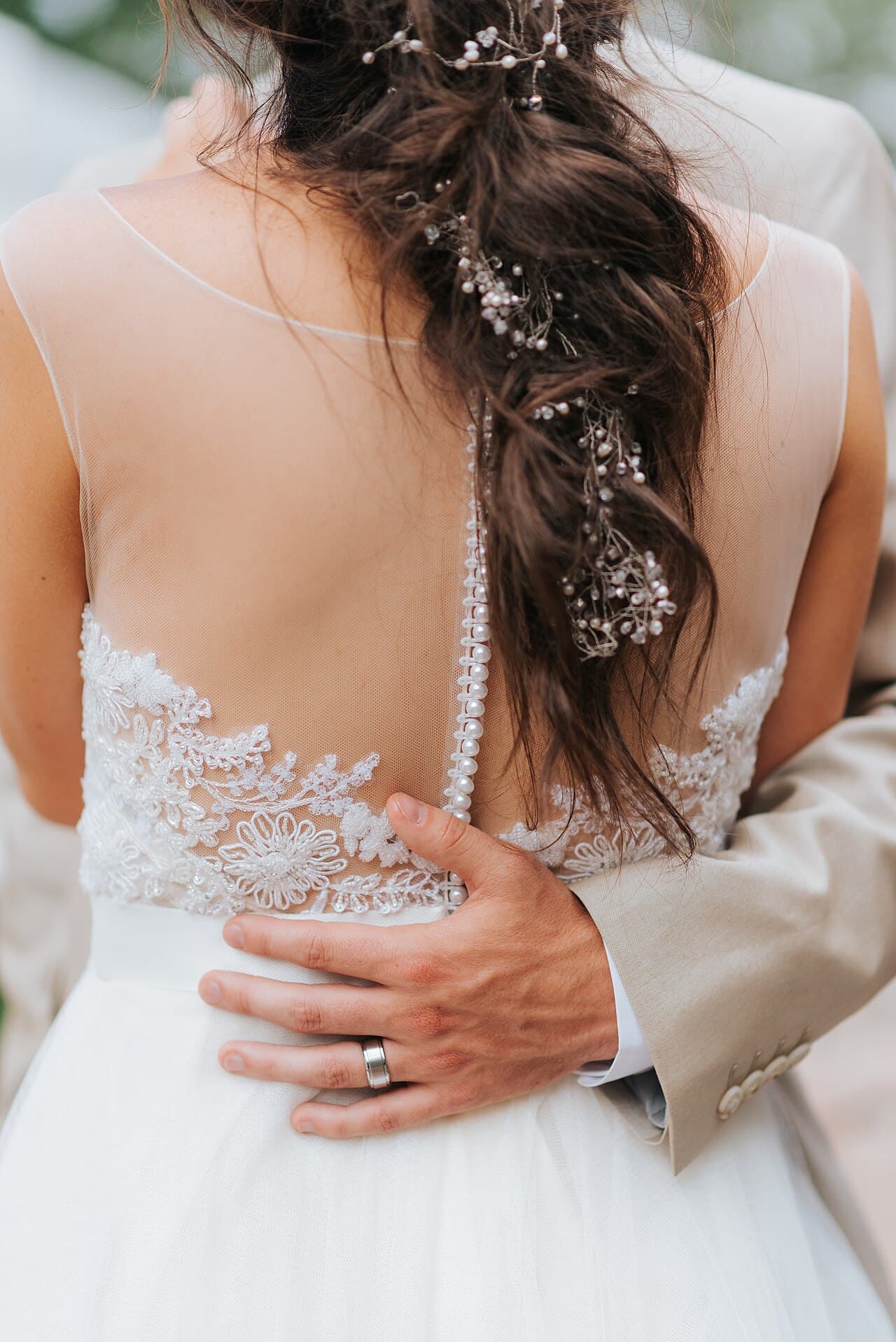 Bride's back with a braided hairstyle