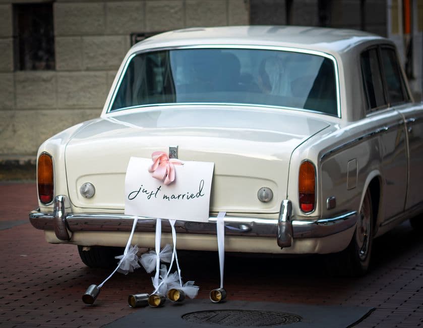 Classic white Rolls Royce adorned with a 'Just Married' sign, perfect for weddings.